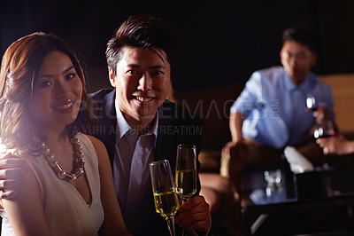 Buy stock photo Portrait of a young couple enjoying a night out together in a bar