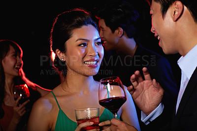 Buy stock photo Shot of a young couple enjoying a night out together in a bar