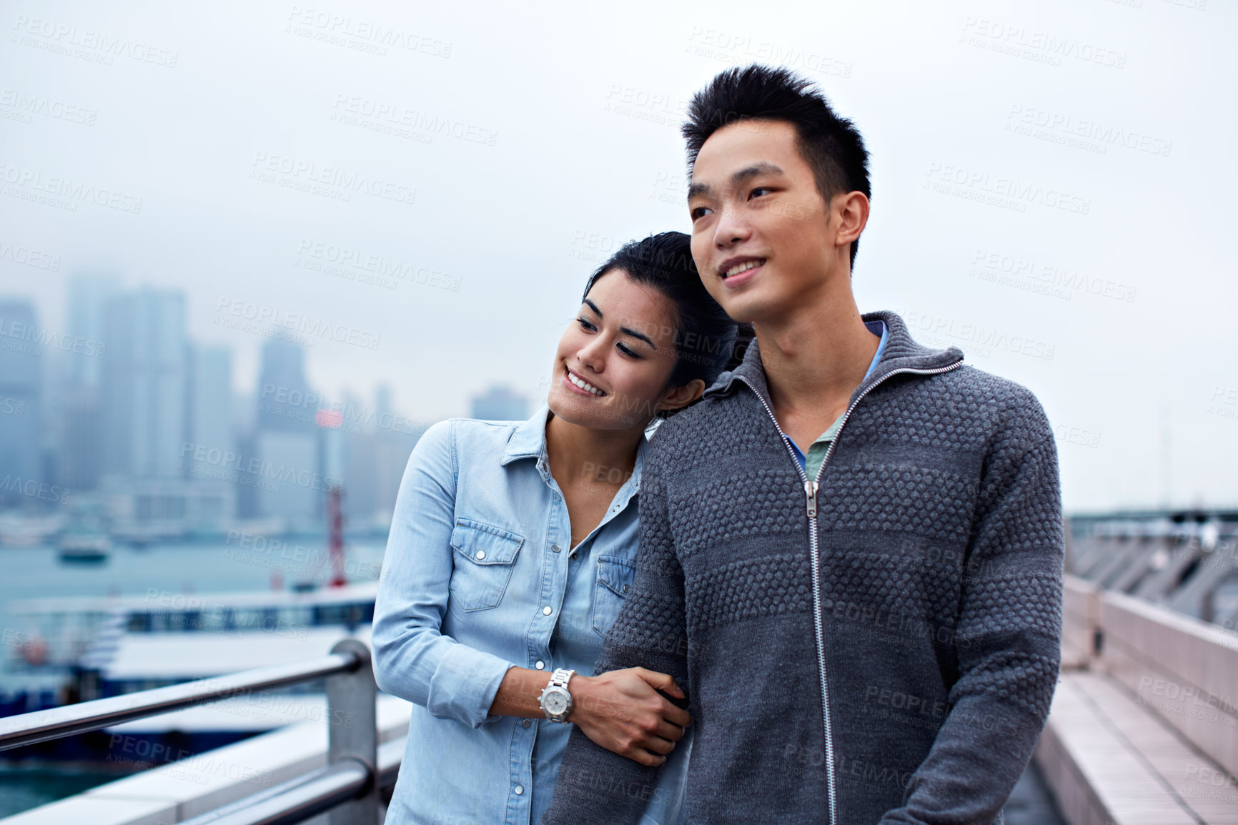 Buy stock photo Couple, smile and hug on promenade for holiday, date and walk for sightseeing or bonding. Asian man, happy woman and tourist with trip, vacation and travel for honeymoon or romance at waterfront