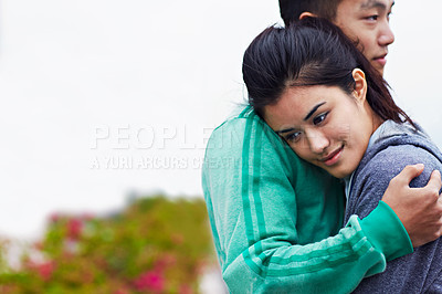 Buy stock photo Shot of an affectionate young asian couple hugging