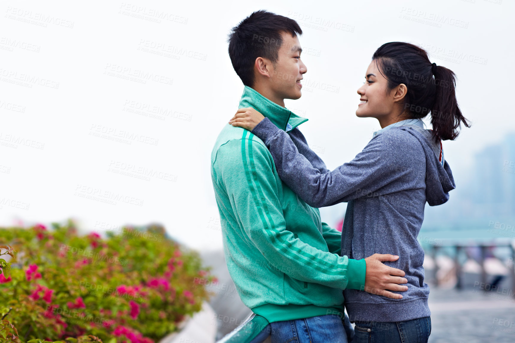 Buy stock photo Happy, hug and Asian couple on bridge for love, affection or bonding on weekend together. Dating, outdoor space or man with woman relax for relationship, trust or travel on holiday, vacation or break