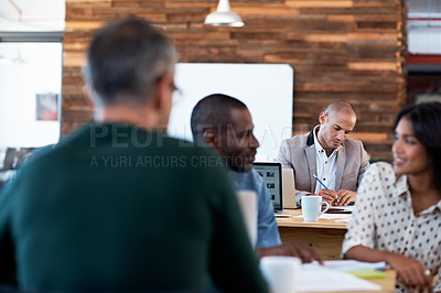 Buy stock photo Shot of a group of people working in an open office