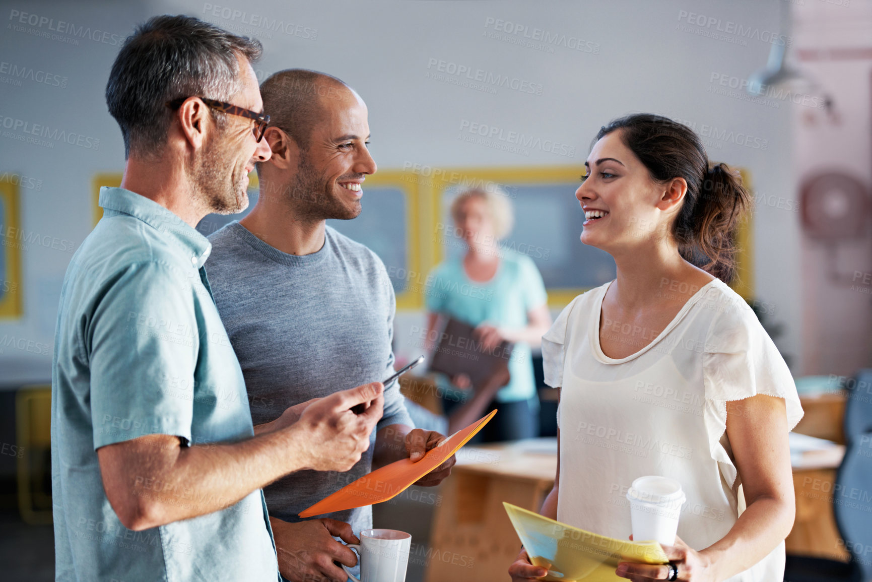 Buy stock photo Shot of a group of designers having a discussion in an office