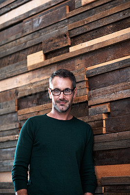 Buy stock photo Portrait of a designer leaning against a wooden wall