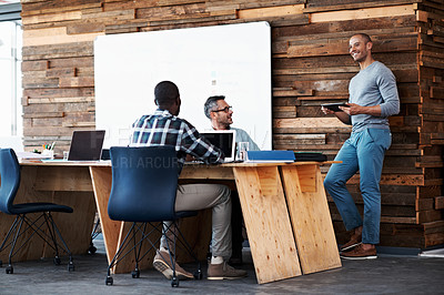 Buy stock photo Shot of a group of colleagues having a discussion in an office