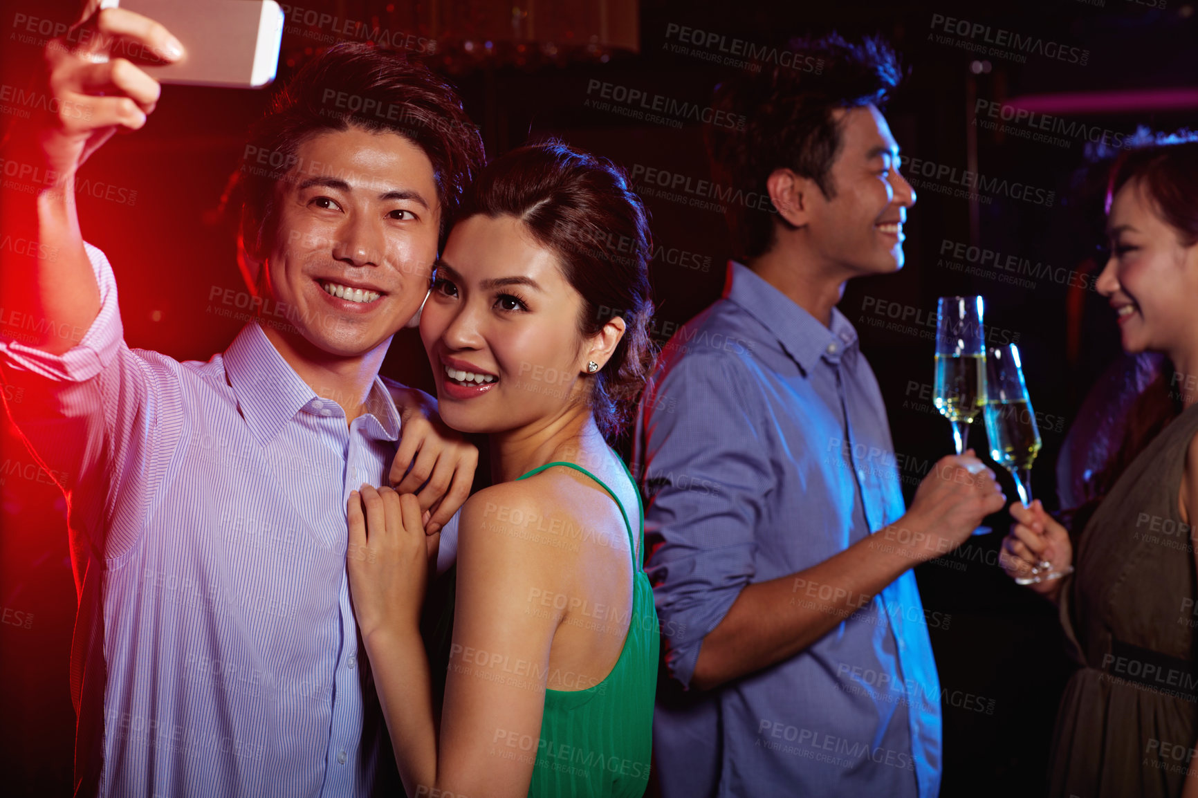 Buy stock photo Couple, selfie and hug in nightclub with smile, memory or social media post with people at party. Man, woman and happy flare with photography for bonding, nightlife or celebrate with picture in Japan