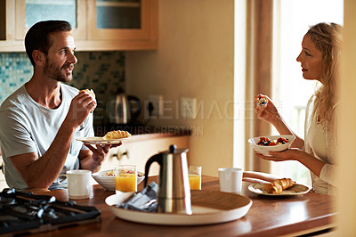 Buy stock photo Cropped shot of a couple having breakfast in the kitchen