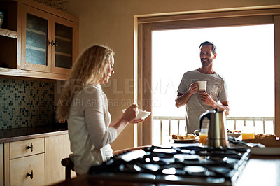 Buy stock photo Cropped shot of a couple having breakfast in the kitchen