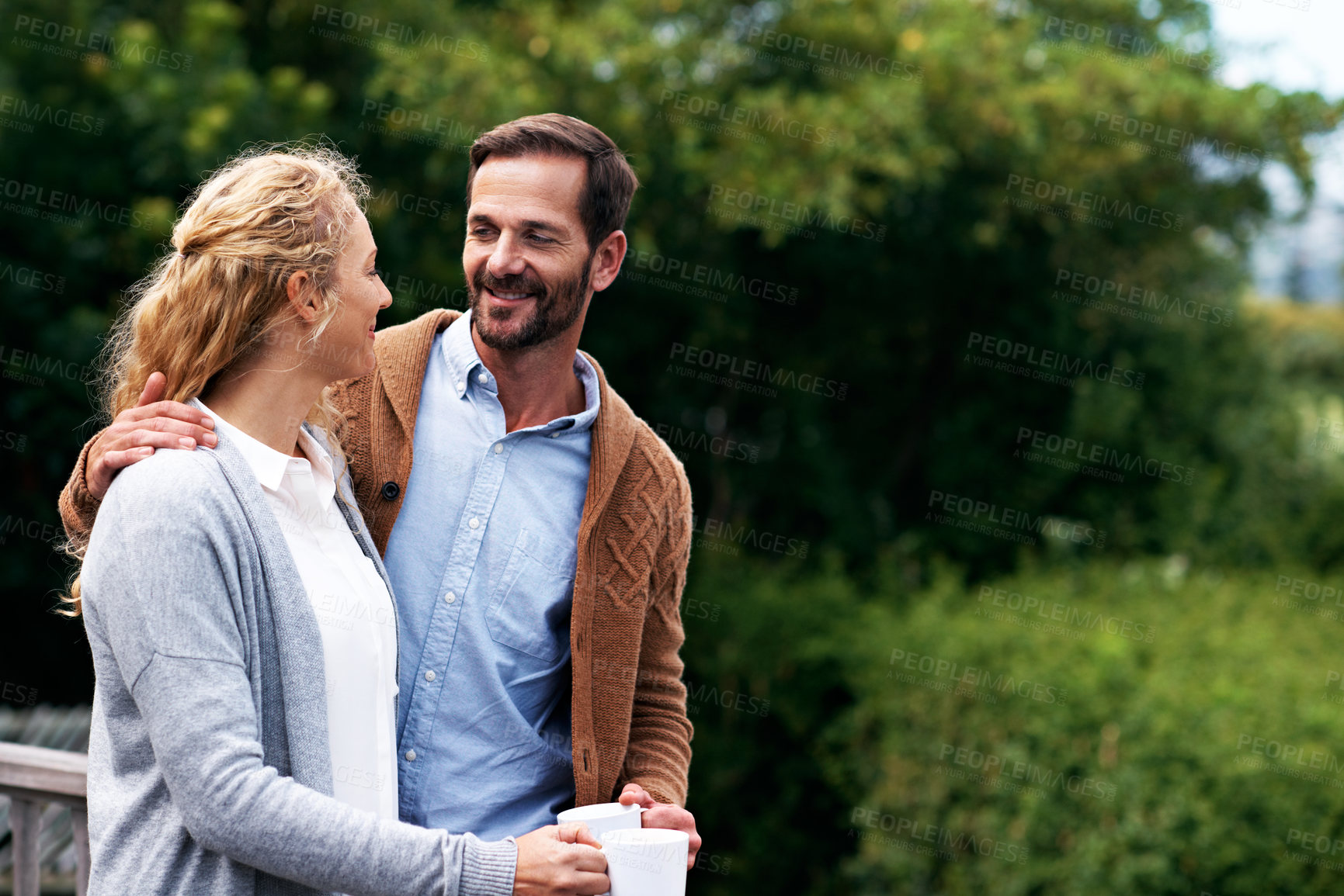 Buy stock photo Talking, coffee and couple on terrace in morning for bonding, conversation and connection. Marriage, happy and man with woman on balcony with drink, chat and affection for love, relationship and view