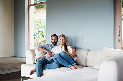 Buy stock photo Shot of a couple relaxing on their living room sofa