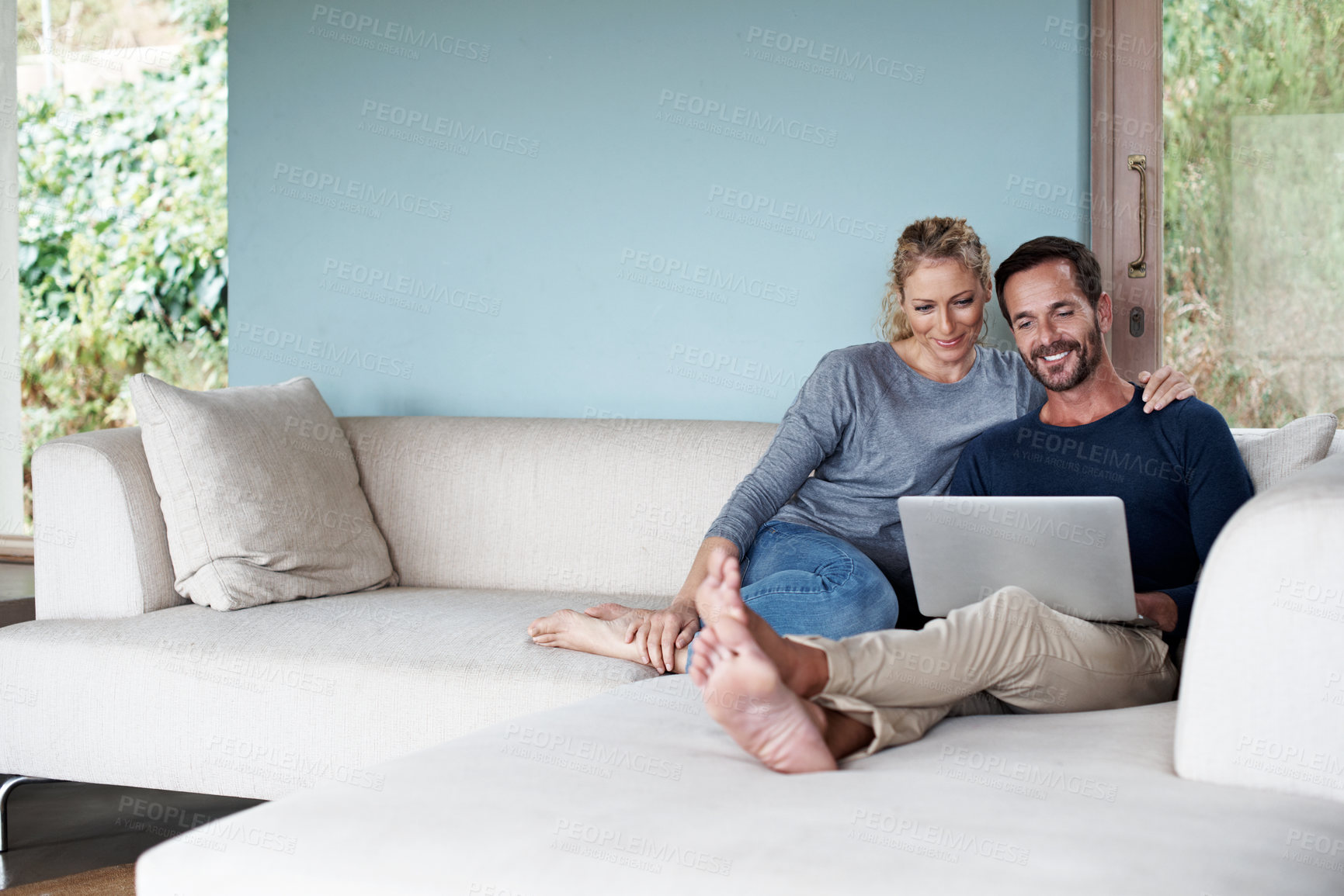 Buy stock photo Sofa, relax and couple on laptop on weekend for online streaming, watching videos and movie in home. Happy, marriage and man with woman on computer for website, internet and subscription for bonding