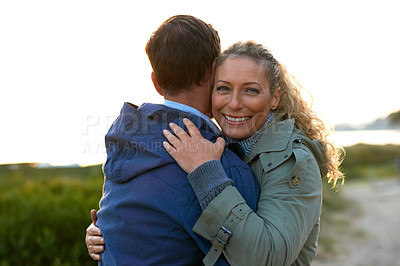Buy stock photo Cropped shot of an affectionate couple hugging outdoors