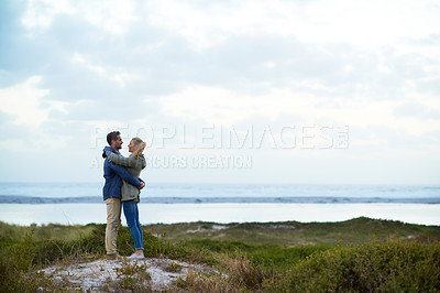 Buy stock photo Full length shot of an affectionate couple standing face-to-face outdoors
