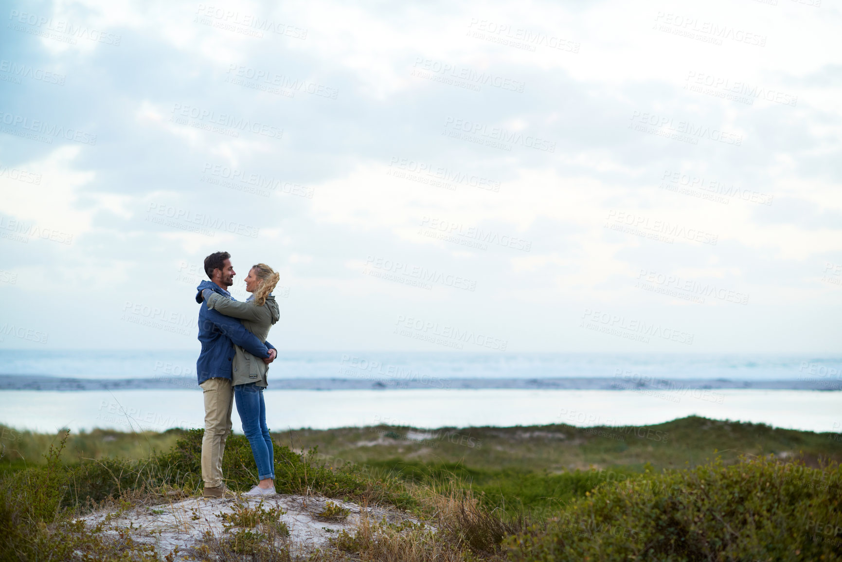 Buy stock photo Full length shot of an affectionate couple standing face-to-face outdoors