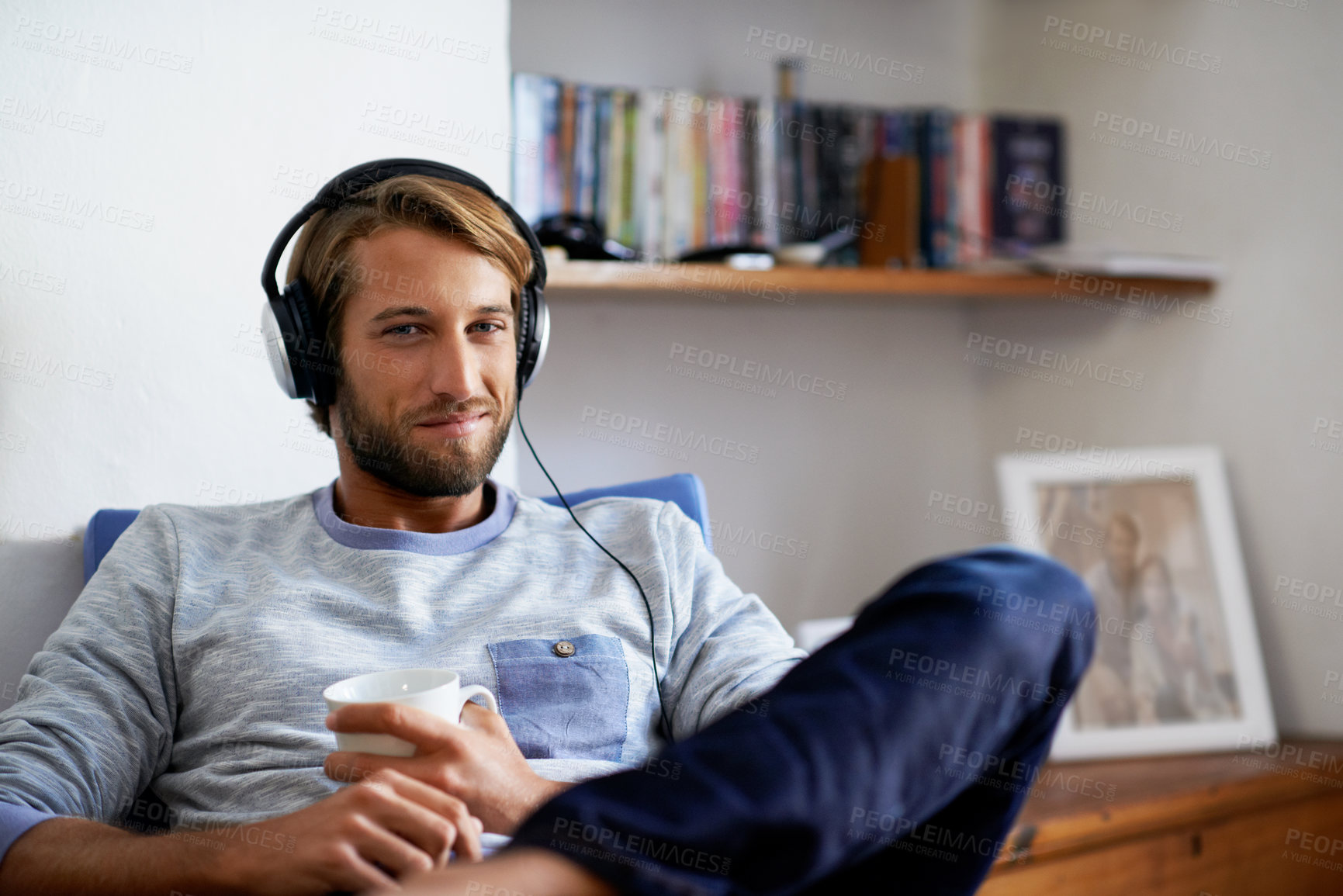 Buy stock photo Man, portrait and coffee with headphones in home, relax and smile with drink for day off with audio. Male person, happy and rest with mug, sound or radio with listening to music, chill and break