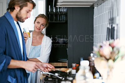Buy stock photo Shot of a young couple cooking breakfast together in the kitchen
