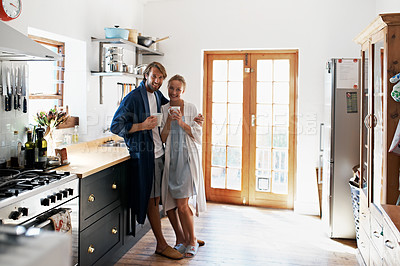 Buy stock photo Portrait of a young couple drinking coffee in the kitchen in the morning