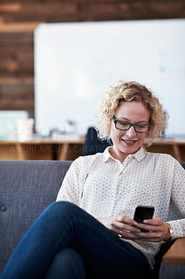 Buy stock photo Cropped shot of a businesswoman sending a text message