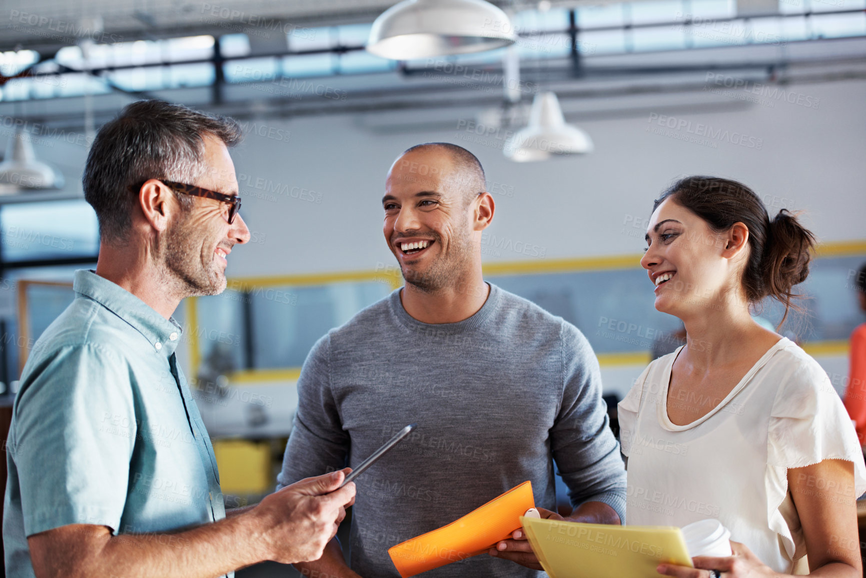 Buy stock photo Cropped shot of three businesspeople talking in an office