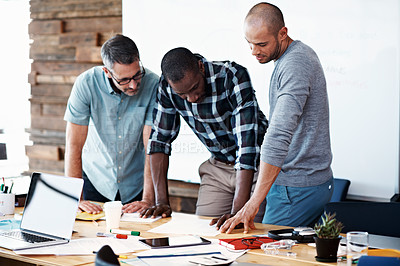 Buy stock photo Cropped shot of three businessmen working in the office