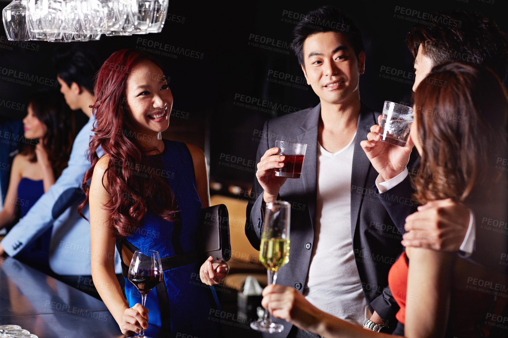 Buy stock photo Shot of two young asian couples drinking together in a nightclub