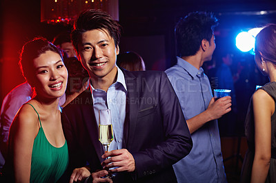 Buy stock photo Portrait of a young couple enjoying a night out together in a club