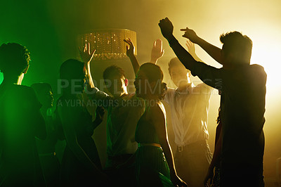 Buy stock photo Shot of a group of young asian people dancing together in a nightclub