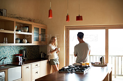 Buy stock photo Shot of a couple talking in the kitchen