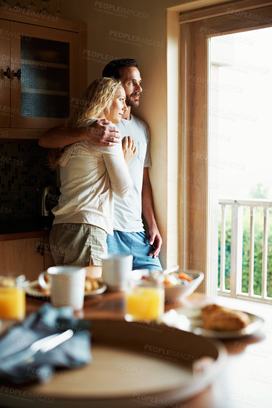 Buy stock photo Window, breakfast and vision with couple in kitchen in home for morning, bonding and love. Support, connection and hug with man and woman thinking in house for marriage, trust and relax together