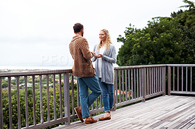 Buy stock photo Shot of a couple standing on their balcony