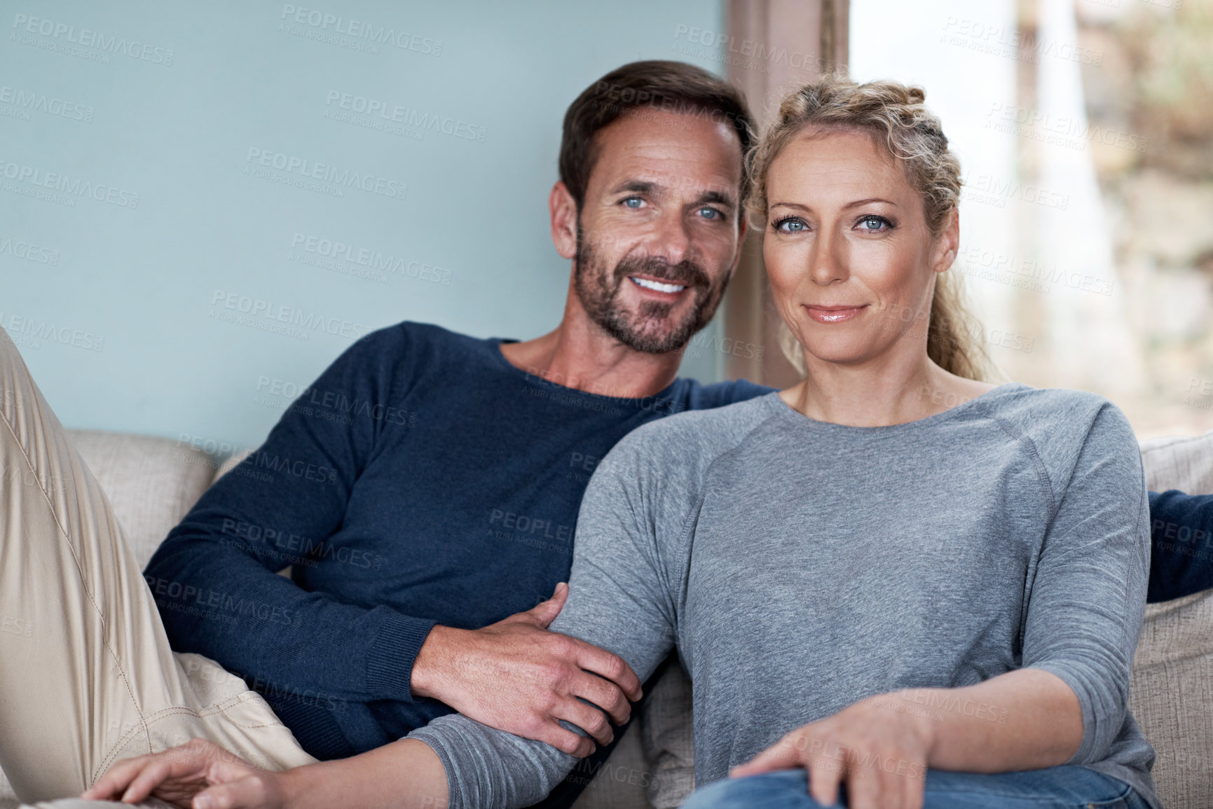 Buy stock photo Shot of a couple relaxing on their living room sofa