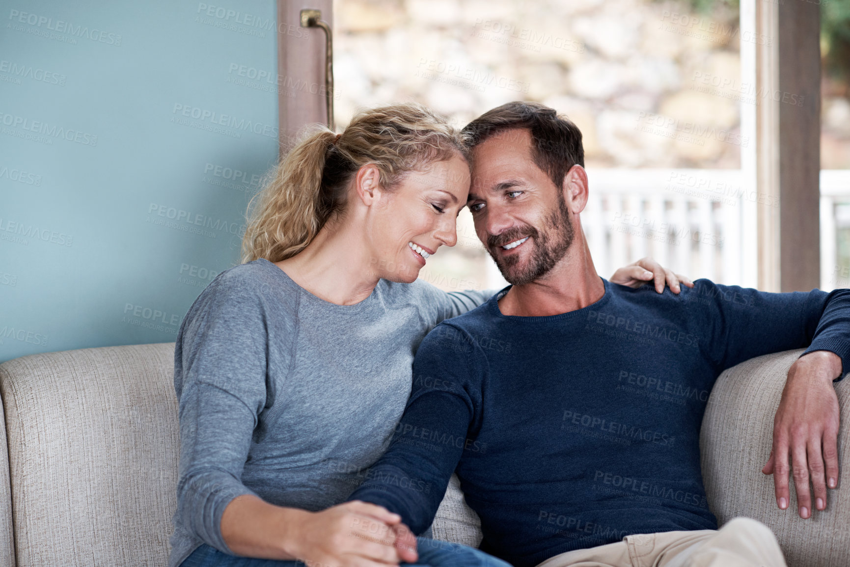Buy stock photo Couple, relax and holding hands in home with smile, love and bonding together for stress relief. Care, mature people or affection on sofa with partner, connection and healthy relationship for weekend
