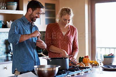 Buy stock photo Shot of a couple having some wine while preparing a meal in the kitchen