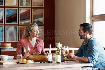 Buy stock photo Cropped shot of a couple having dinner at home