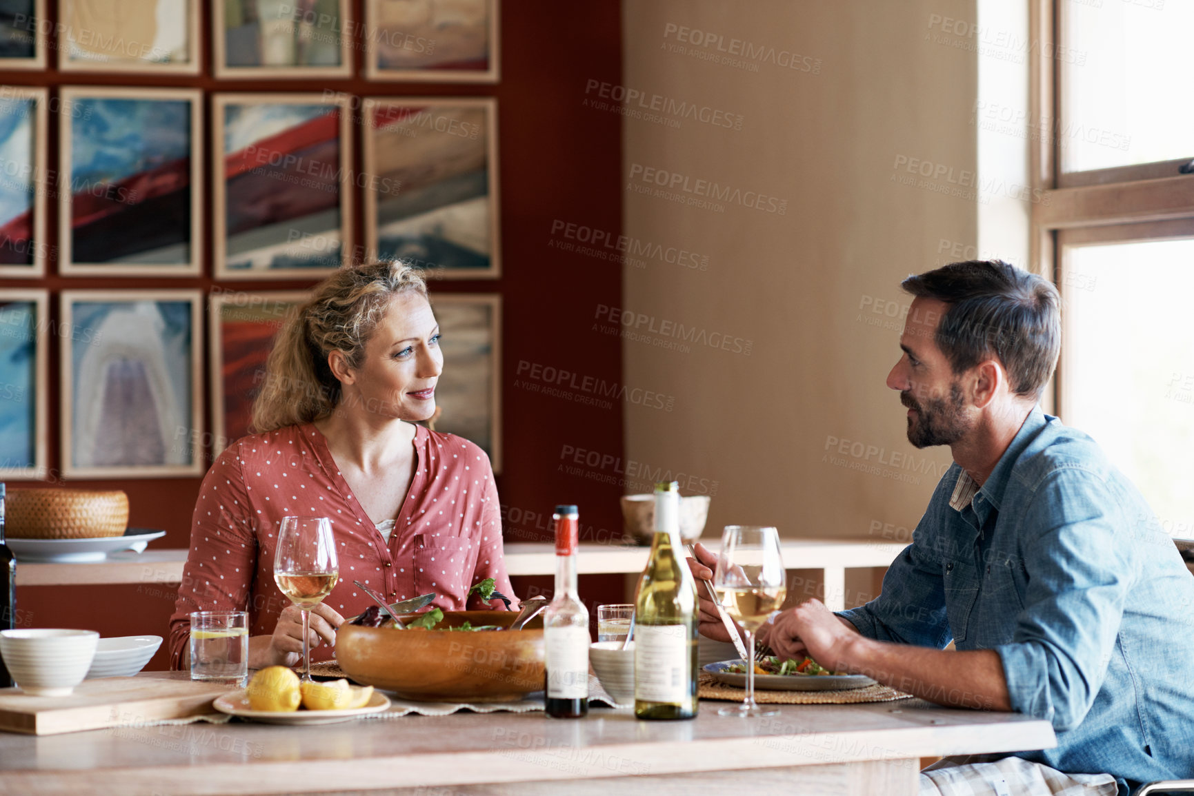 Buy stock photo Cropped shot of a couple having dinner at home