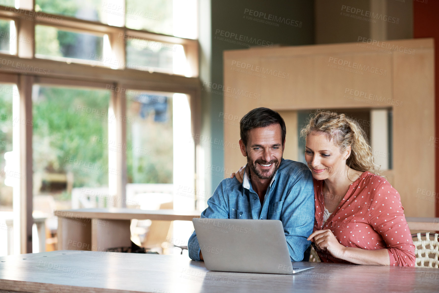 Buy stock photo Cropped shot of a couple using a laptop at home