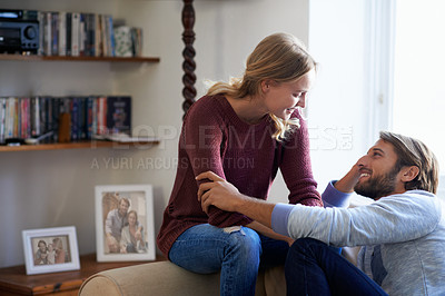 Buy stock photo Shot of a loving young couple relaxing on the sofa at home