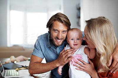 Buy stock photo Portrait of a smiling young dad with his wife and their baby girl at home