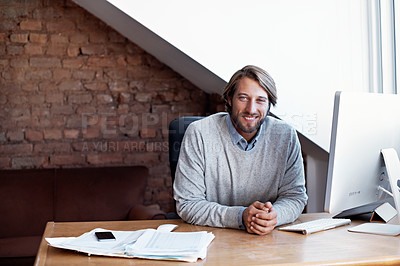 Buy stock photo Portrait of a young man working on his computer in his home study