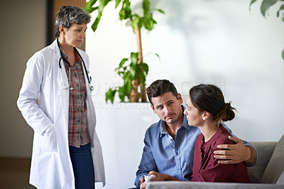 Buy stock photo Shot of a husband comforting his wife in a hospital waiting room
