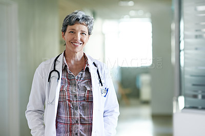 Buy stock photo Portrait of a confident mature doctor standing in a hospital