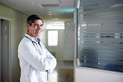 Buy stock photo Portrait of a confident mature doctor standing in a hospital