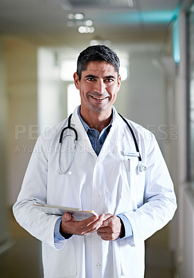 Buy stock photo Portrait of a confident mature doctor standing in a hospital