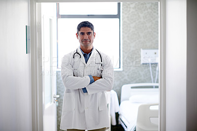 Buy stock photo Portrait of a confident mature doctor standing in a hospital