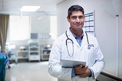 Buy stock photo Portrait of a confident mature doctor standing in a hospital