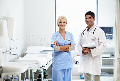 Buy stock photo Portrait of two confident doctors standing together in a hospital