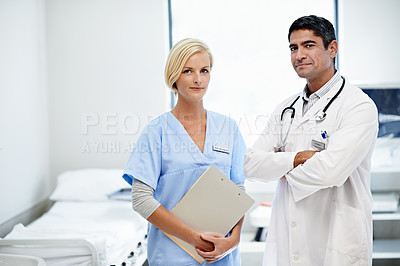 Buy stock photo Portrait of two confident doctors standing together in a hospital