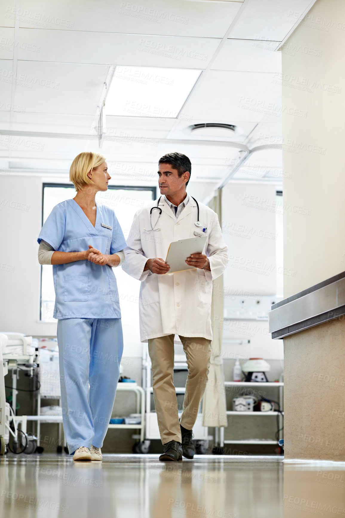 Buy stock photo Doctor, nurse or walk with health checklist for case discussion, medical results or care planning. Healthcare team, people or clipboard in hallway for ward round, treatment options or clinic workflow