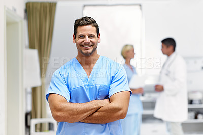Buy stock photo Portrait of a confident doctor with medical staff in the background
