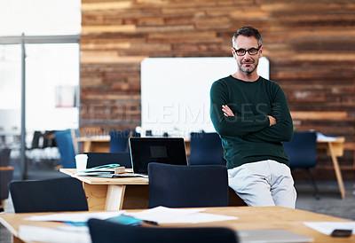 Buy stock photo Cropped portrait of a businessman leaning on his desk